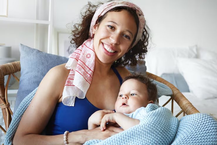 A mother resting at home with her newborn.