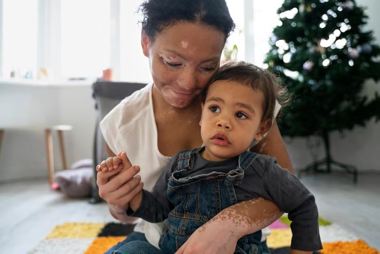 A mother and toddler playing together on the floor at home.